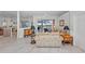 Light-filled living room features neutral paint, tile flooring, and sliding glass doors offering serene outdoor views at 8106 Arlewood Cir, Port Charlotte, FL 33981