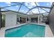A gorgeous swimming pool with an extended covered lanai and patio seating at 8106 Arlewood Cir, Port Charlotte, FL 33981