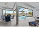 Screened pool area with outdoor seating and a beautiful view of the surrounding waterfront at 8106 Arlewood Cir, Port Charlotte, FL 33981