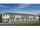 Charming townhome showcasing a well-maintained lawn and symmetrical window and door placement at 8689 Daybreak St, Sarasota, FL 34241