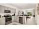 Modern kitchen with stainless steel appliances, sleek countertops, and an open design at 8689 Daybreak St, Sarasota, FL 34241