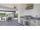 Outdoor kitchen and patio area with built-in grill, seating, and pergola, ideal for entertaining guests at 8689 Daybreak St, Sarasota, FL 34241