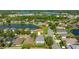 Aerial view of a gray roof home surrounded by lake-filled neighborhoods and tree-lined streets at 8804 Founders Cir, Palmetto, FL 34221
