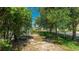 Fenced-in backyard featuring partial grass, shade trees, and perimeter landscaping at 8804 Founders Cir, Palmetto, FL 34221