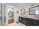 Bathroom with double sink vanity, walk-in closet, and glass door shower enclosure at 8804 Founders Cir, Palmetto, FL 34221