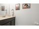 Half bath featuring a pedestal sink with framed artwork at 8804 Founders Cir, Palmetto, FL 34221