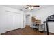 Bright bedroom featuring a ceiling fan, closet, wood floors, and a treadmill at 8804 Founders Cir, Palmetto, FL 34221
