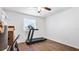 This bedroom features wood-look flooring, a ceiling fan and a window for natural light at 8804 Founders Cir, Palmetto, FL 34221