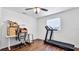 The bedroom offers a window, wood-look flooring, a ceiling fan and space for home work-out equipment at 8804 Founders Cir, Palmetto, FL 34221