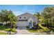 Charming two-story home featuring a beautiful front yard with lush landscaping and a welcoming entrance at 8804 Founders Cir, Palmetto, FL 34221