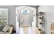 Bright foyer with ceramic tile flooring, an arched entryway, and neutral wall paint at 8804 Founders Cir, Palmetto, FL 34221