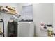 Bright laundry room features a modern washer, dryer, utility sink, and ample storage space at 8804 Founders Cir, Palmetto, FL 34221