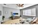 Comfortable living room area with tile floors, entertainment center, ceiling fan, and natural light at 8804 Founders Cir, Palmetto, FL 34221