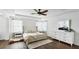 Bright main bedroom boasts tray ceilings, hardwood floors, and ensuite bath with walk in closets at 8804 Founders Cir, Palmetto, FL 34221
