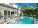 Inviting screened-in pool area with table and chairs, ideal for poolside dining and entertaining at 8804 Founders Cir, Palmetto, FL 34221