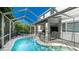 Stunning screened-in pool and patio area features ample seating, a grill, and a ceiling fan at 8804 Founders Cir, Palmetto, FL 34221
