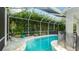 Tranquil screened-in pool with lush landscaping provides a private and serene retreat at 8804 Founders Cir, Palmetto, FL 34221