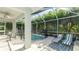 Relaxing screened-in pool area with lounge chairs and seating, perfect for outdoor enjoyment at 8804 Founders Cir, Palmetto, FL 34221
