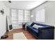 Cozy sitting room with blue sofa, built-in shelving, wood floors and a brightly lit window at 8804 Founders Cir, Palmetto, FL 34221