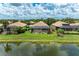 Aerial view showcases screened-in lanais overlooking a serene pond, surrounded by landscaped backyards at 8820 Heritage Sound Dr, Bradenton, FL 34212