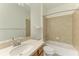 Clean bathroom features a single sink vanity, tiled shower and tub with a large mirror at 8820 Heritage Sound Dr, Bradenton, FL 34212