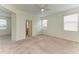 Bright, carpeted bedroom with ceiling fan and natural light from two large windows at 8820 Heritage Sound Dr, Bradenton, FL 34212