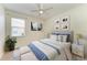 Comfortable bedroom featuring neutral tones, soft bedding, and a bright window view at 8820 Heritage Sound Dr, Bradenton, FL 34212