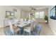 Dining room with seating for eight, light blue accent rug, and natural lighting at 8820 Heritage Sound Dr, Bradenton, FL 34212