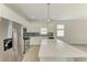 Bright kitchen features stainless appliances, white cabinets, mosaic backsplash, and an expansive island at 8820 Heritage Sound Dr, Bradenton, FL 34212