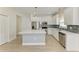 Bright kitchen with white cabinets, stainless steel appliances, a center island and backsplash at 8820 Heritage Sound Dr, Bradenton, FL 34212