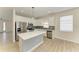Modern kitchen with white cabinets, stainless steel appliances, and a center island with white countertop at 8820 Heritage Sound Dr, Bradenton, FL 34212