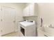 Laundry room with modern washer and dryer and additional cabinet storage at 8820 Heritage Sound Dr, Bradenton, FL 34212