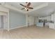 Open-concept living area flows into a modern kitchen, featuring light wood floors and natural light at 8820 Heritage Sound Dr, Bradenton, FL 34212