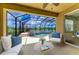 Screened-in pool and patio area offering a serene outdoor living space with water views and comfortable seating at 8820 Heritage Sound Dr, Bradenton, FL 34212