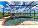Beautiful pool and spa with a screened enclosure and a view of the tranquil lake at 8820 Heritage Sound Dr, Bradenton, FL 34212