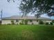 Home exterior featuring a well-manicured green lawn and simple landscaping at 9926 Gulfstream Blvd, Englewood, FL 34224