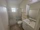 Neat bathroom featuring a shower-tub combo, a toilet, vanity, and storage, offering necessary amenities at 9926 Gulfstream Blvd, Englewood, FL 34224