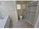 Cozy bathroom featuring a tiled shower with glass doors, a toilet, and a modern vanity for your needs at 9926 Gulfstream Blvd, Englewood, FL 34224