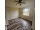 Cozy bedroom with modern flooring, neutral walls, and a bright window to let in sunlight at 9926 Gulfstream Blvd, Englewood, FL 34224
