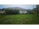 Single story home featuring a lush green front yard and mature landscaping at 9926 Gulfstream Blvd, Englewood, FL 34224