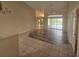 Open-concept living area with a combination of tile and wood flooring and sliding glass doors at 9926 Gulfstream Blvd, Englewood, FL 34224