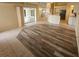 Spacious living area with open floor plan, tile and laminate flooring, and access to lanai at 9926 Gulfstream Blvd, Englewood, FL 34224