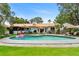 Beautiful backyard with a pool, tiki umbrellas, and lounging area at 1112 Montezuma Dr, Bradenton, FL 34209