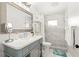 Bathroom featuring a single sink vanity, decorative mirror, and a separate walk-in shower with tiled walls at 1112 Montezuma Dr, Bradenton, FL 34209