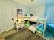 A bedroom with bunk beds, a dresser, artwork, wood floors, and a lamp at 1112 Montezuma Dr, Bradenton, FL 34209