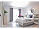 A bedroom with gray walls, wood floors, desk, chair, and sliding door to a porch area at 1112 Montezuma Dr, Bradenton, FL 34209