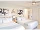 Comfortable bedroom with two beds, light blue accents, and simple decor with ceiling fan at 1112 Montezuma Dr, Bradenton, FL 34209