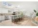 Bright kitchen with stainless steel appliances, skylight, an island with bar seating, and open dining at 1112 Montezuma Dr, Bradenton, FL 34209