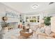 Cozy living room with a decorative fireplace, a large window, and comfortable seating at 1112 Montezuma Dr, Bradenton, FL 34209