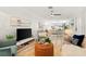 Bright living room featuring contemporary furnishings, natural light, and open layout to the dining area at 1112 Montezuma Dr, Bradenton, FL 34209